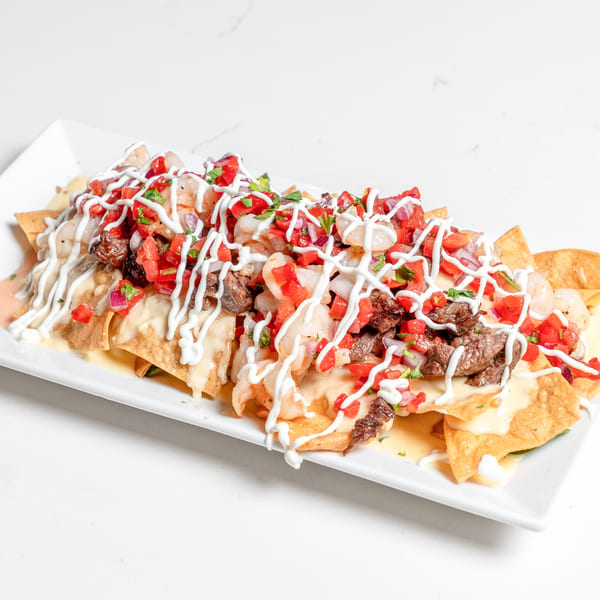 Pear Street Bistro's loaded nachos with steak, shrimp, pico de gallo, and a drizzle of white sauce.